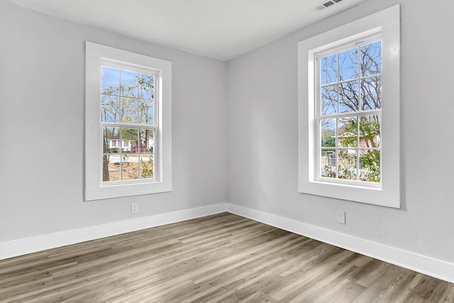 spare room featuring light hardwood / wood-style flooring