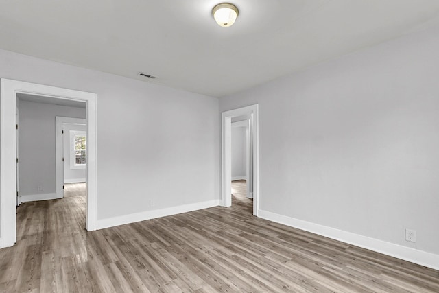 unfurnished room featuring wood-type flooring