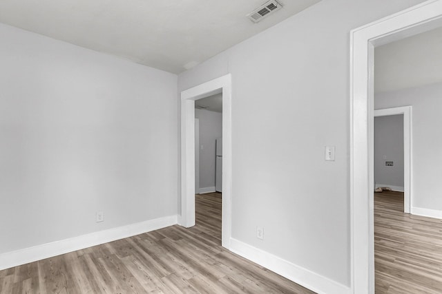 spare room featuring light hardwood / wood-style flooring