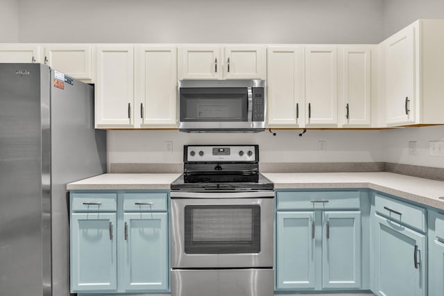 kitchen featuring white cabinets, blue cabinets, and stainless steel appliances