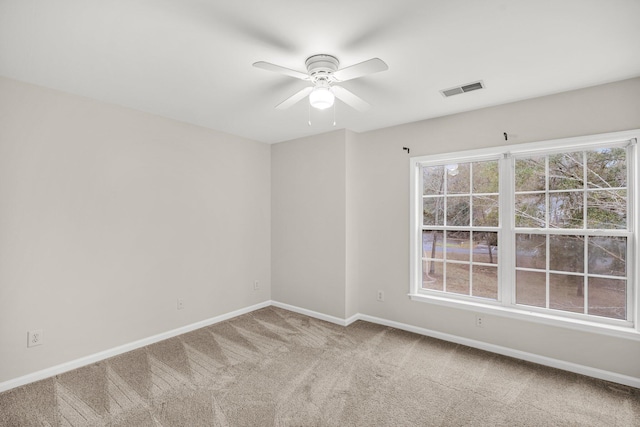 spare room with ceiling fan and carpet flooring