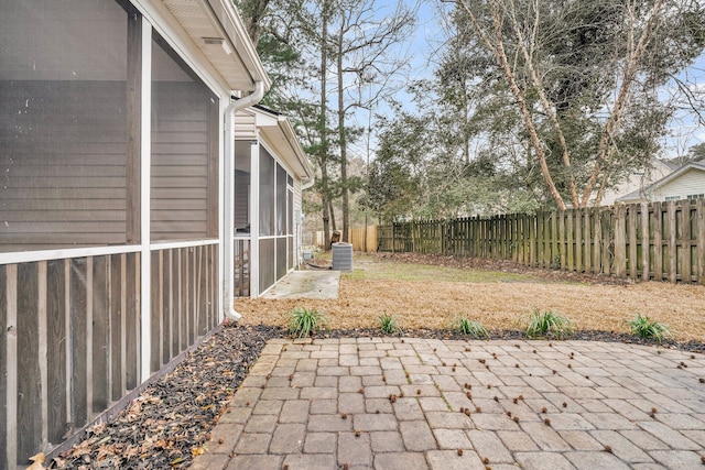 view of patio featuring central AC and a sunroom