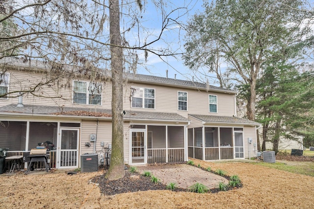 back of property featuring a patio area, a sunroom, and central air condition unit