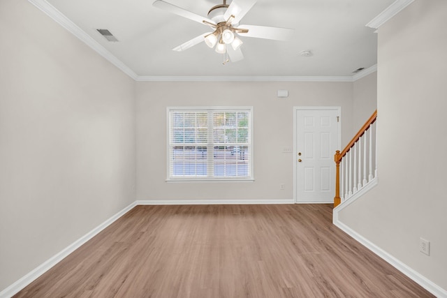 interior space with ceiling fan, crown molding, and light hardwood / wood-style flooring