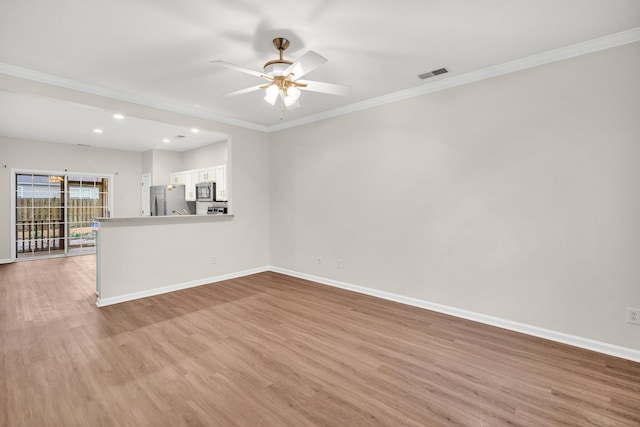 empty room with ceiling fan, ornamental molding, and light hardwood / wood-style flooring