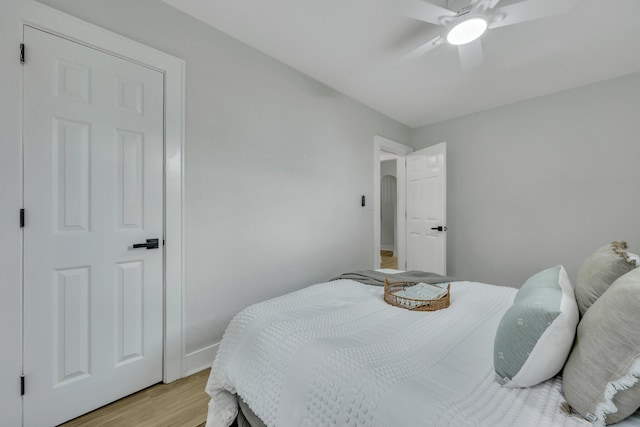 bedroom with ceiling fan and light hardwood / wood-style floors