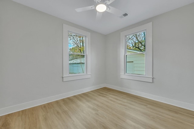 unfurnished room featuring ceiling fan, light hardwood / wood-style floors, and a wealth of natural light