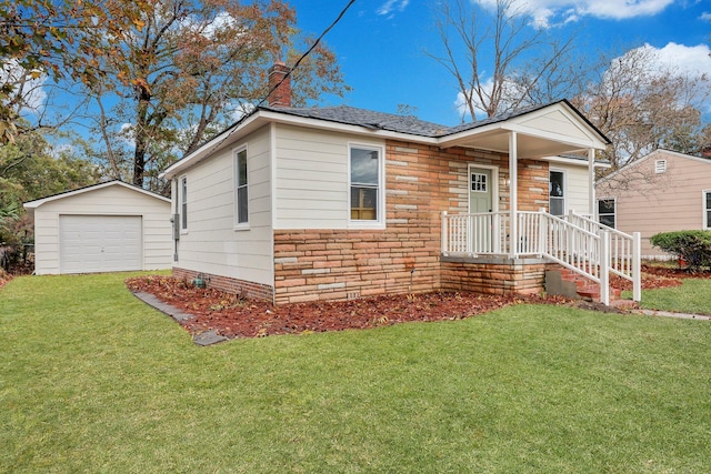 bungalow with a garage, an outbuilding, and a front yard