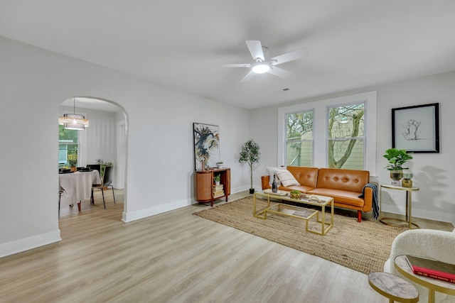 living room featuring light wood-type flooring and ceiling fan