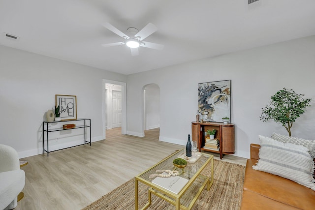 living room featuring light wood-type flooring and ceiling fan