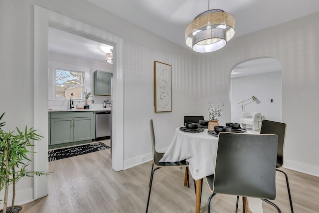 dining room with light hardwood / wood-style flooring and sink