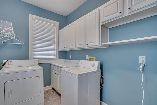 laundry area featuring baseboards, cabinet space, and separate washer and dryer