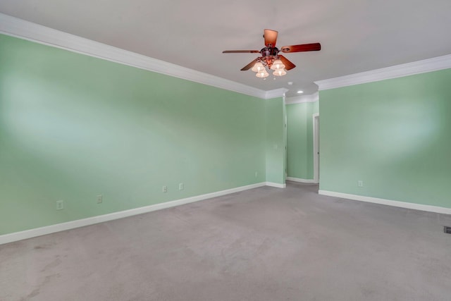 carpeted spare room featuring baseboards, ceiling fan, and ornamental molding