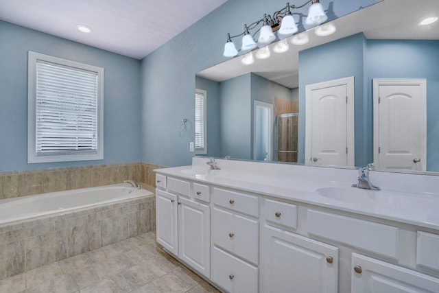 bathroom featuring a sink, tile patterned floors, double vanity, and a stall shower