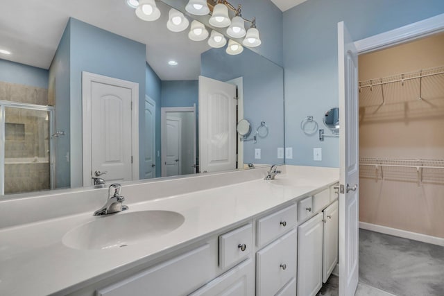 bathroom with a sink, a closet, double vanity, and a stall shower