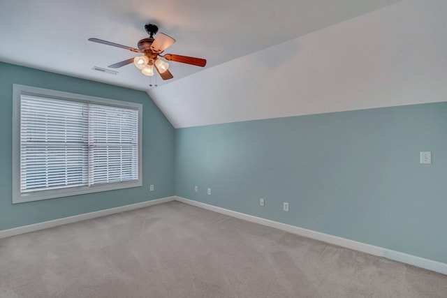 additional living space featuring ceiling fan, baseboards, lofted ceiling, and light colored carpet