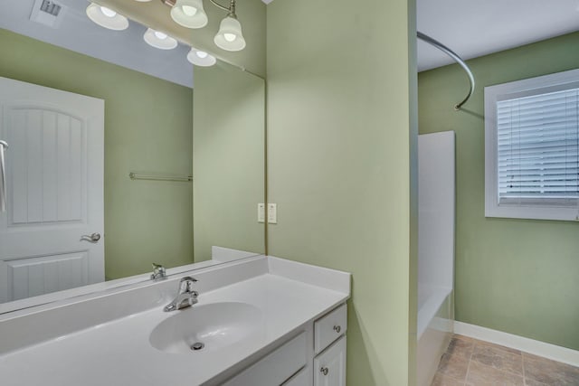 full bath with visible vents, vanity, baseboards, and bathing tub / shower combination