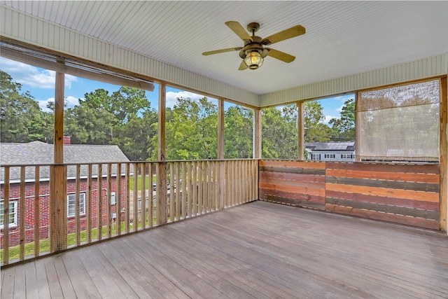 unfurnished sunroom with a ceiling fan