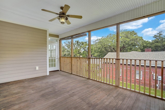 unfurnished sunroom with a ceiling fan