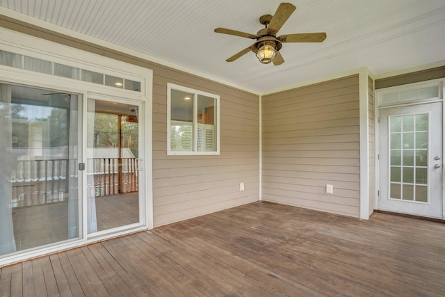 unfurnished sunroom with a ceiling fan