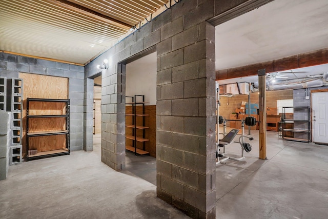 unfinished basement with concrete block wall