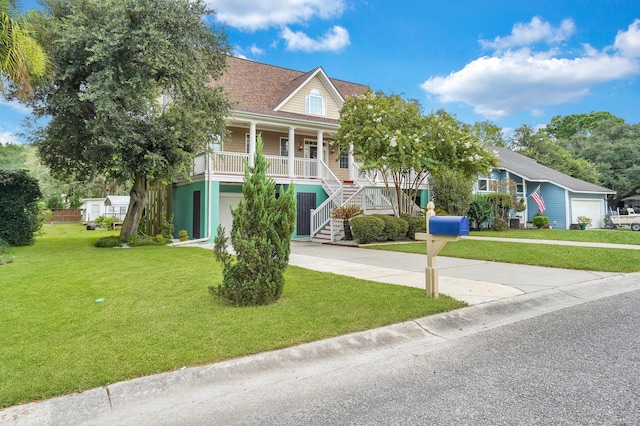 raised beach house featuring stairway, a porch, driveway, and a garage