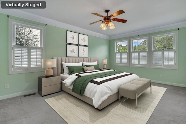 bedroom featuring light colored carpet, ornamental molding, and baseboards