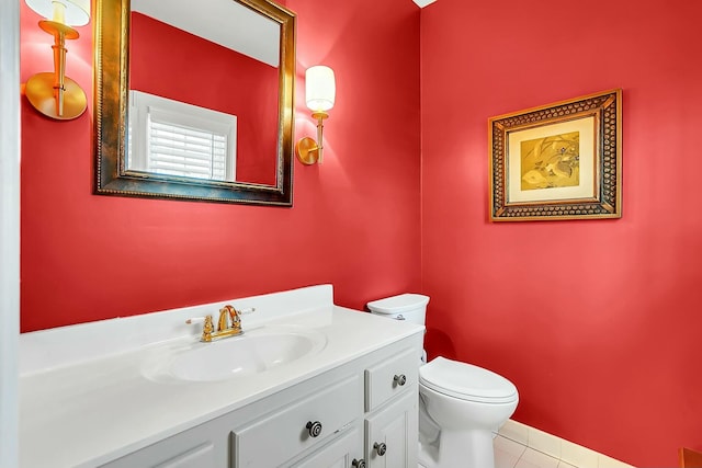 bathroom with toilet, tile patterned flooring, and vanity