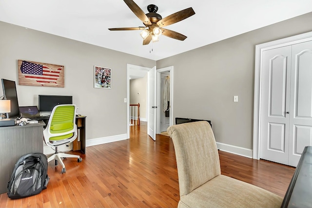 office featuring ceiling fan, wood finished floors, and baseboards