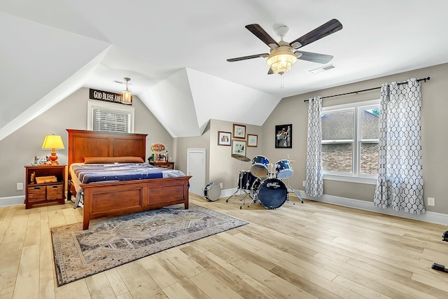 bedroom with vaulted ceiling, baseboards, visible vents, and light wood-style floors