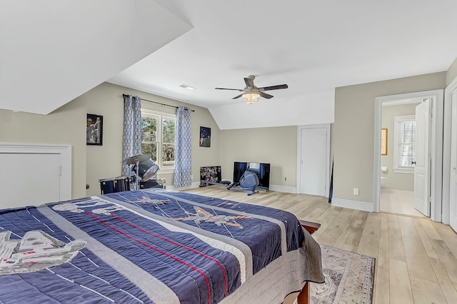 bedroom featuring light wood-type flooring, visible vents, multiple windows, and lofted ceiling