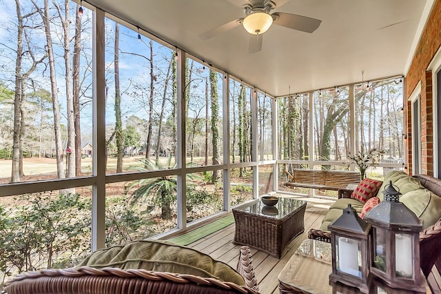 sunroom featuring ceiling fan