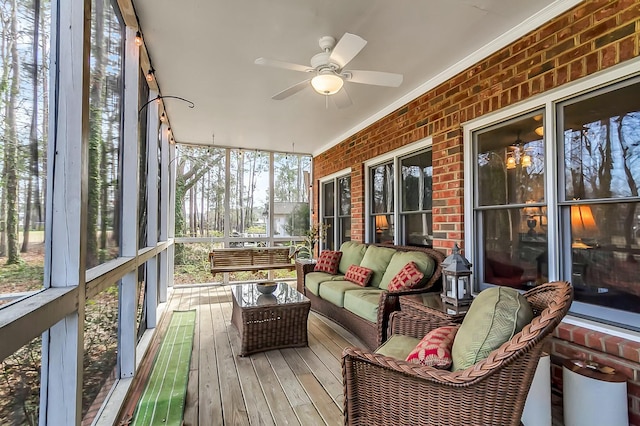 sunroom featuring ceiling fan