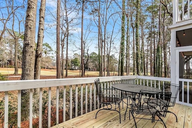 wooden terrace with outdoor dining area