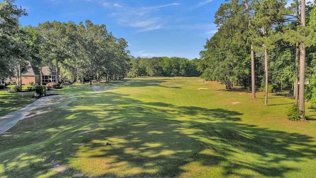 view of community featuring a lawn and golf course view