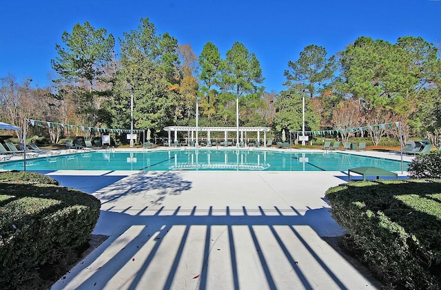 community pool with a patio and a pergola