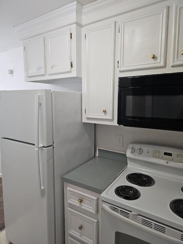 kitchen with white cabinets and white appliances