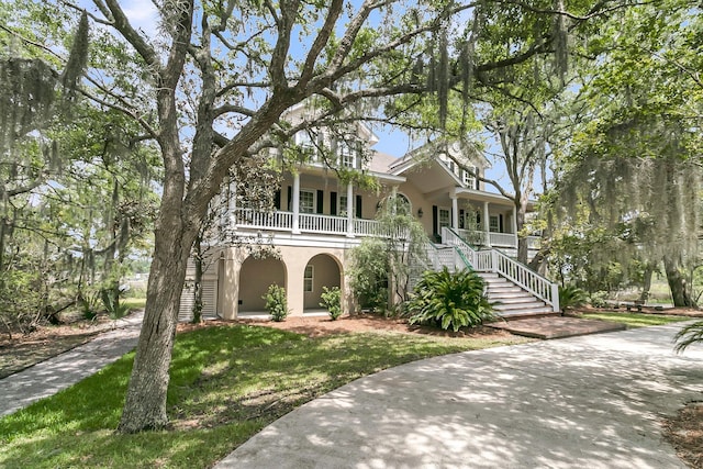 4702 Blockhouse Ln, Hollywood, SC 29449 - view of front of home with covered porch, stairs, stucco siding, and a front lawn