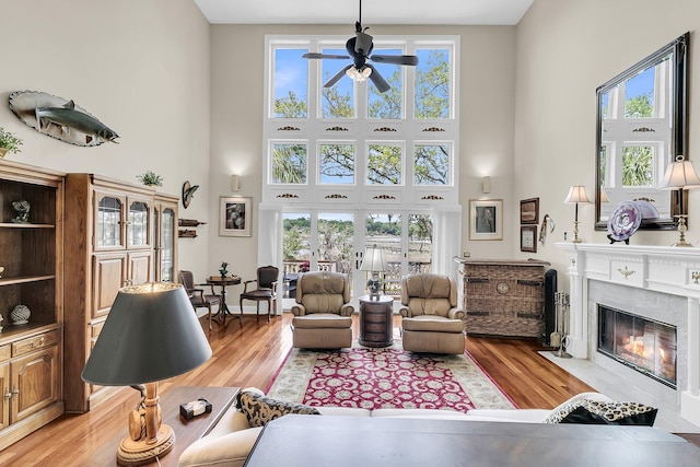 4702 Blockhouse Ln, Hollywood, SC 29449 - living area featuring a towering ceiling, a ceiling fan, light wood-type flooring, and a fireplace
