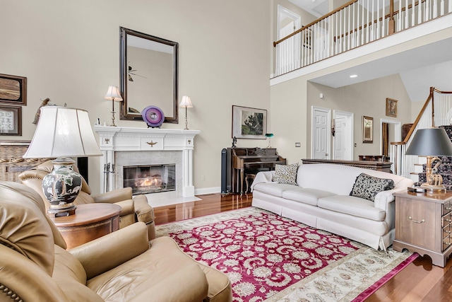 4702 Blockhouse Ln, Hollywood, SC 29449 - living area featuring a high ceiling, wood finished floors, stairway, a high end fireplace, and baseboards