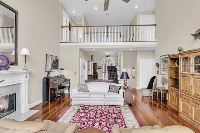 4702 Blockhouse Ln, Hollywood, SC 29449 - living area featuring a ceiling fan, a premium fireplace, wood finished floors, a towering ceiling, and stairs