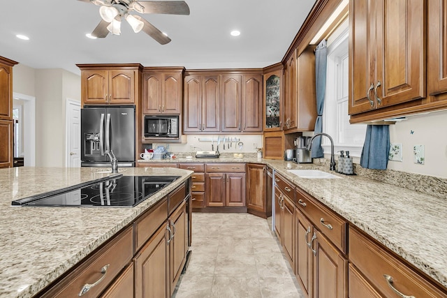 4702 Blockhouse Ln, Hollywood, SC 29449 - kitchen featuring black appliances, a sink, light stone countertops, a ceiling fan, and brown cabinets
