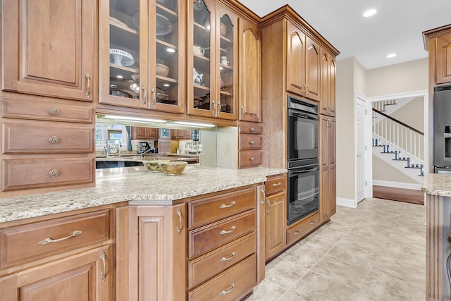 4702 Blockhouse Ln, Hollywood, SC 29449 - kitchen with light stone counters, glass insert cabinets, brown cabinets, baseboards, and recessed lighting