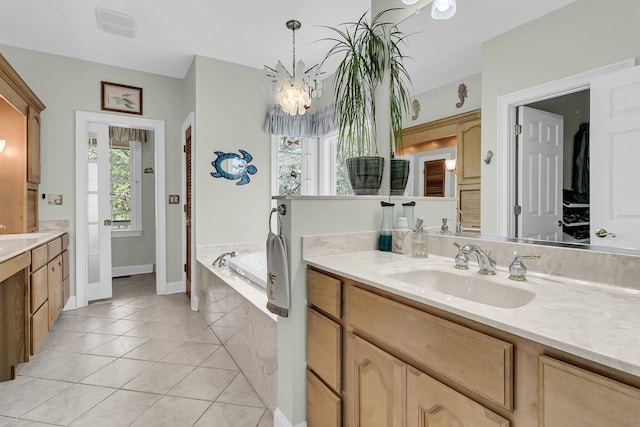 4702 Blockhouse Ln, Hollywood, SC 29449 - full bath featuring vanity, a garden tub, a chandelier, tile patterned flooring, and baseboards