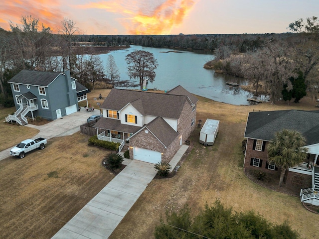 aerial view at dusk with a water view