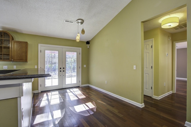 entryway featuring a textured ceiling, visible vents, baseboards, french doors, and dark wood-style floors