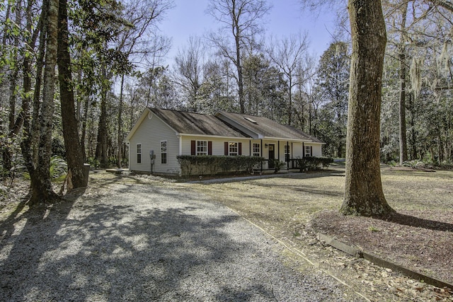 ranch-style home with gravel driveway