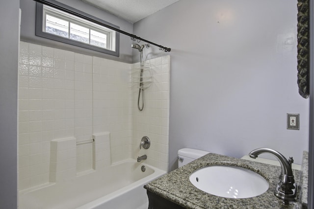 bathroom featuring toilet, vanity, a textured ceiling, and shower / bathing tub combination