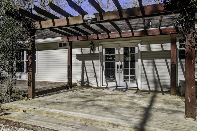 deck with french doors and a pergola