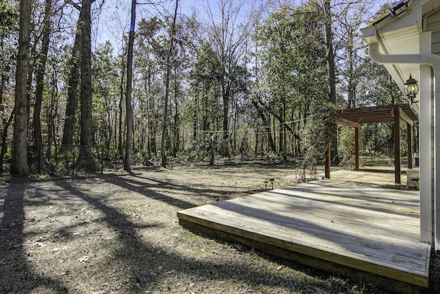 exterior space with fence, a wooden deck, and a pergola